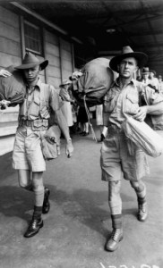 Soldiers wearing their shorts and carrying their kit bags  arriving at the railway station in Brisbane November 1941